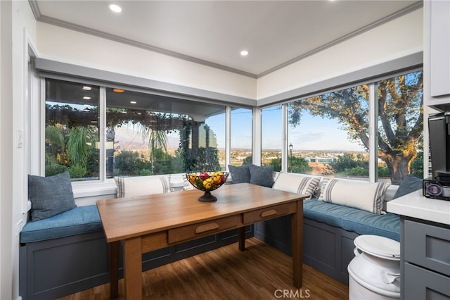 sunroom / solarium featuring breakfast area and a healthy amount of sunlight