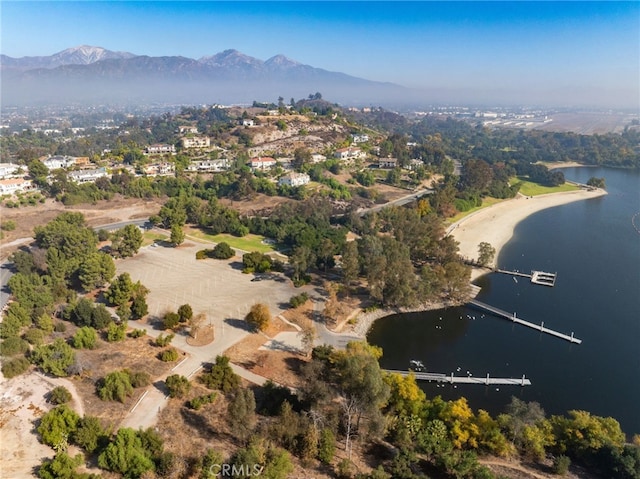 birds eye view of property featuring a water and mountain view