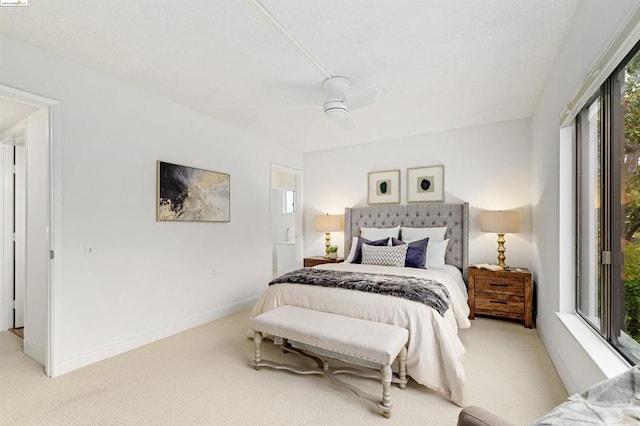 bedroom featuring light colored carpet and ceiling fan