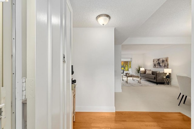 corridor featuring hardwood / wood-style floors and a textured ceiling