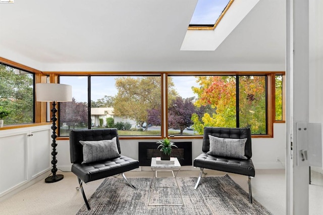 sitting room with carpet floors and a skylight