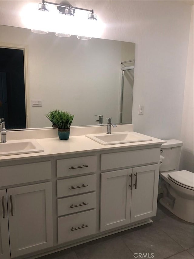 bathroom featuring toilet, walk in shower, tile patterned floors, and vanity