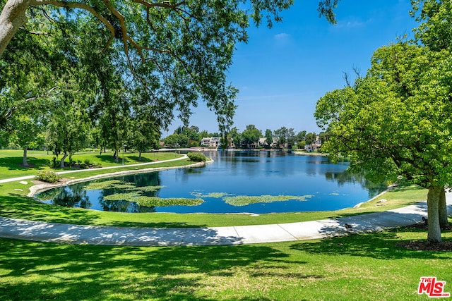 view of community with a yard and a water view