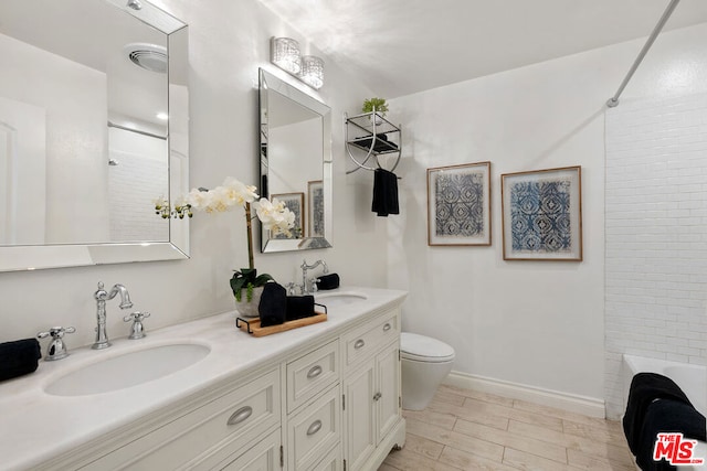 full bathroom with wood-type flooring, vanity, toilet, and shower / tub combination