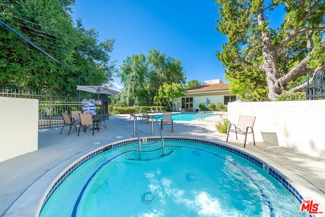 view of swimming pool featuring a patio area