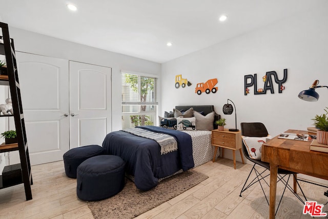 bedroom featuring light wood-type flooring and a closet