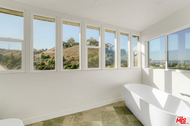 unfurnished sunroom with plenty of natural light