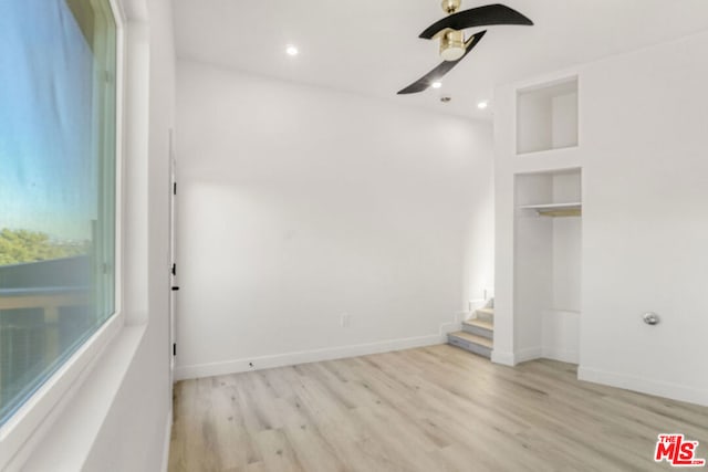 unfurnished bedroom featuring ceiling fan and light hardwood / wood-style flooring