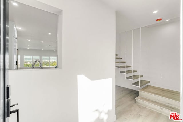 stairs featuring hardwood / wood-style flooring