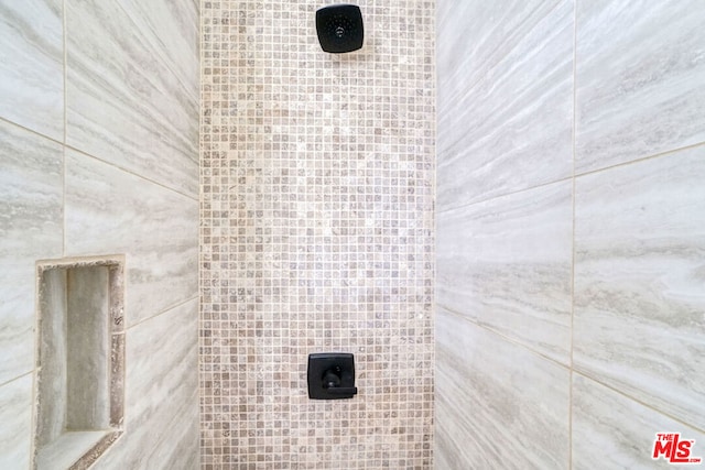 bathroom with a tile shower