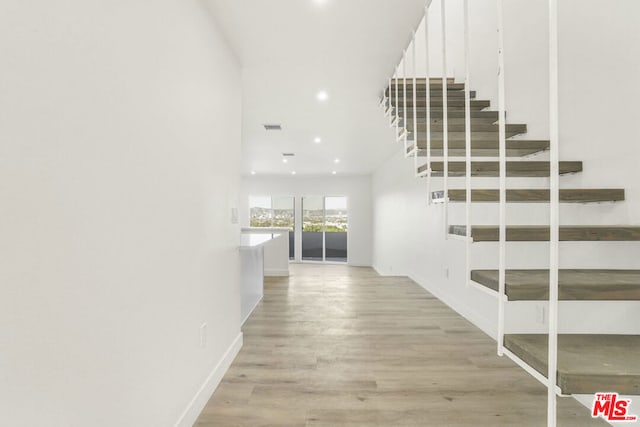 corridor with light hardwood / wood-style flooring