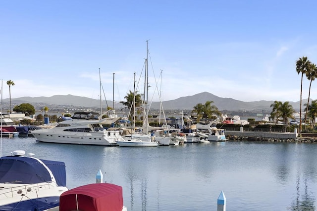 view of water feature with a mountain view and a boat dock