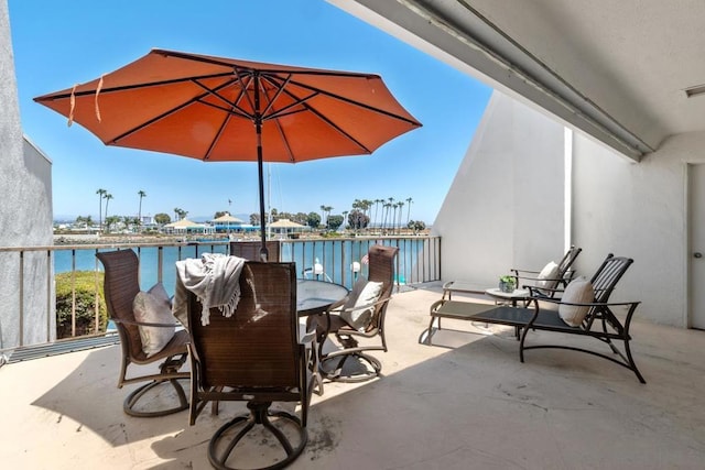 view of patio / terrace with a water view and a balcony