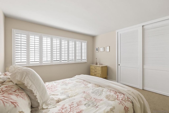 carpeted bedroom with a closet