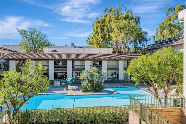 rear view of house with a community pool