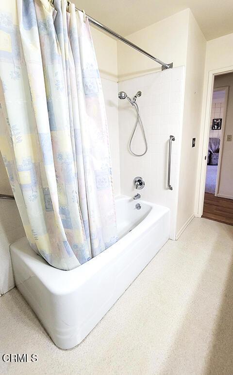 bathroom featuring shower / tub combo with curtain