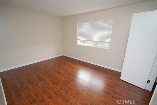 spare room with dark hardwood / wood-style floors