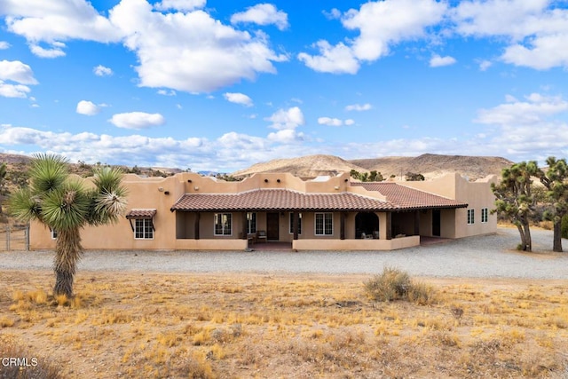 rear view of house featuring a mountain view