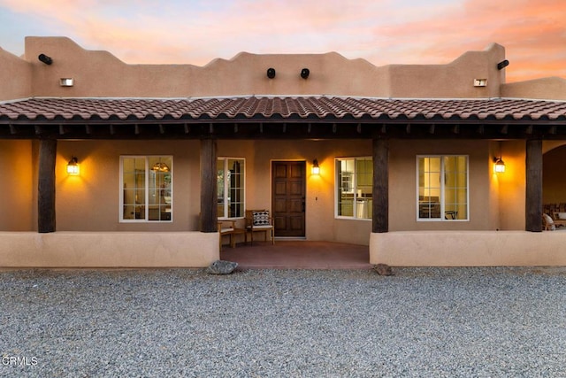 view of back house at dusk