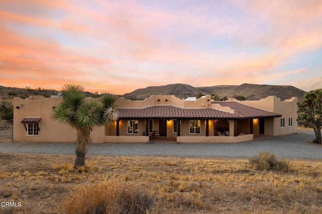 back house at dusk with a mountain view