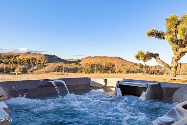 view of swimming pool with a mountain view