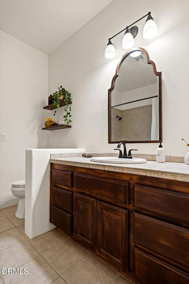 bathroom with tile patterned flooring, vanity, a shower with shower curtain, and toilet