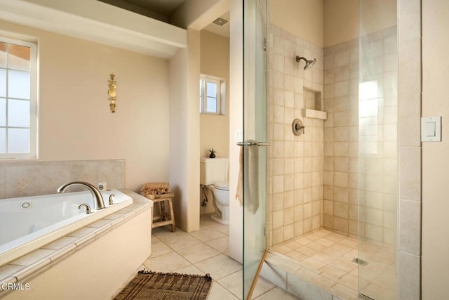 bathroom featuring toilet, plus walk in shower, and tile patterned flooring