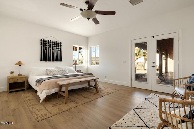 bedroom with wood-type flooring, access to outside, french doors, and ceiling fan