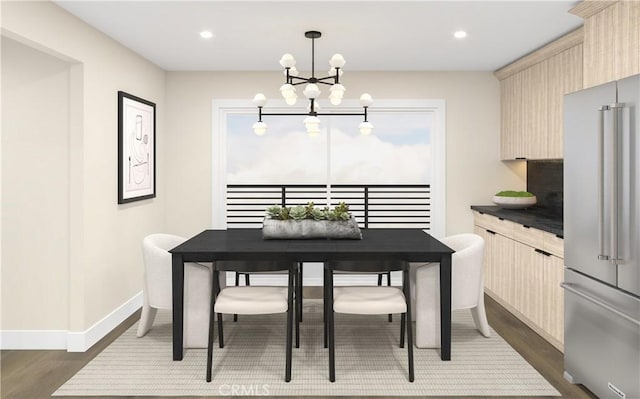 dining area with dark hardwood / wood-style flooring and a notable chandelier