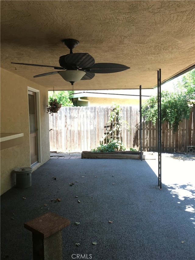 view of patio featuring ceiling fan