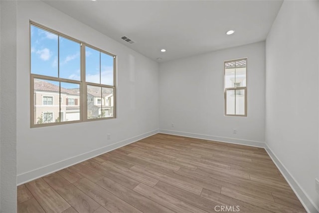 empty room with light hardwood / wood-style floors