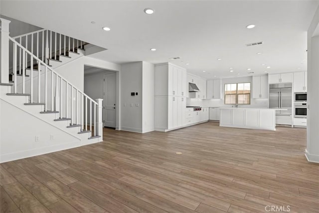 unfurnished living room with light hardwood / wood-style floors