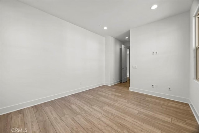 spare room with light hardwood / wood-style floors