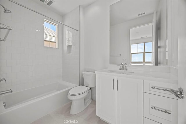 full bathroom with vanity, toilet, and tiled shower / bath