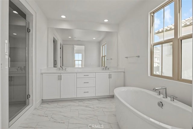 bathroom featuring vanity and separate shower and tub