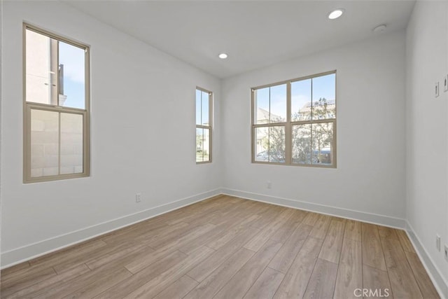 unfurnished room with light hardwood / wood-style floors