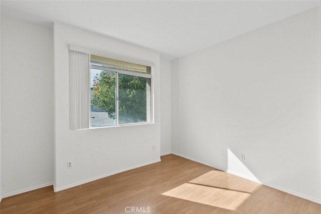 spare room featuring light hardwood / wood-style floors