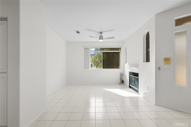 unfurnished living room featuring light tile patterned floors and ceiling fan