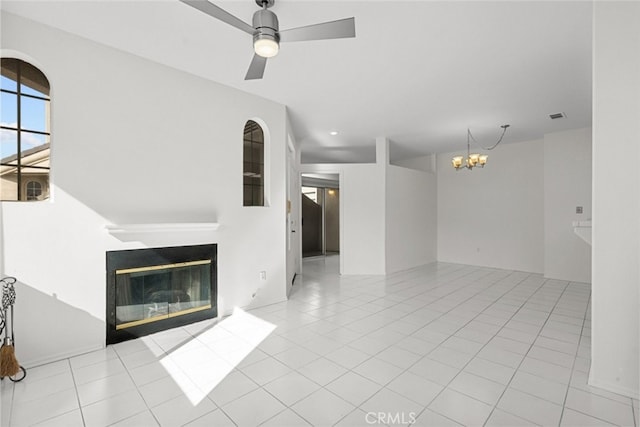 unfurnished living room featuring light tile patterned floors and ceiling fan with notable chandelier