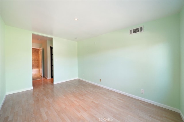 unfurnished room with light hardwood / wood-style floors