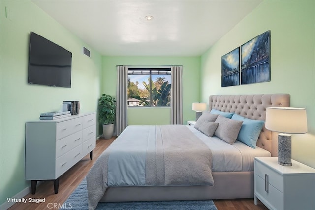 bedroom with dark hardwood / wood-style flooring