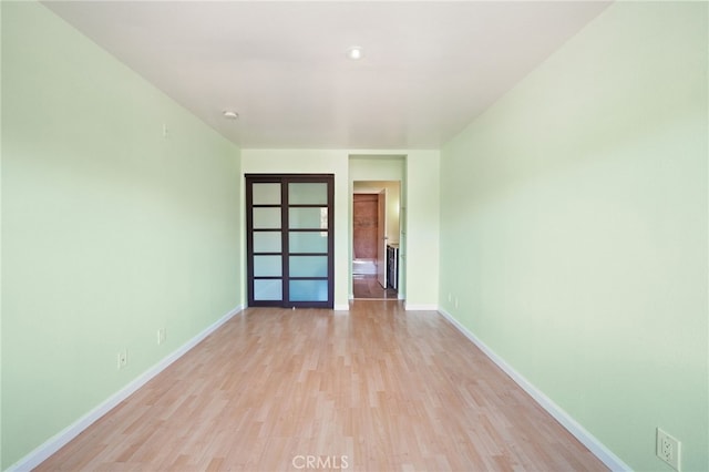 unfurnished room featuring light hardwood / wood-style floors