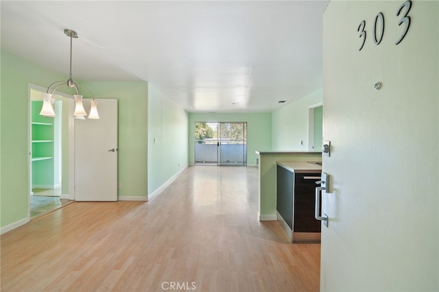 interior space with light wood-type flooring and a chandelier