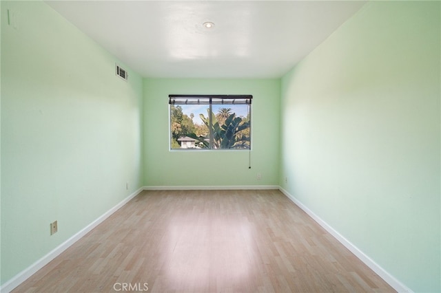 spare room featuring light wood-type flooring