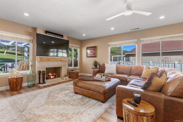 living room with ceiling fan and light hardwood / wood-style floors