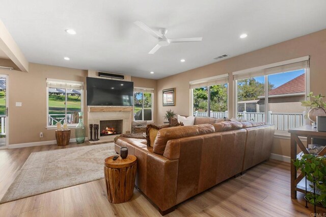 living room featuring ceiling fan and light wood-type flooring