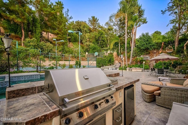 view of patio / terrace with an outdoor kitchen and grilling area