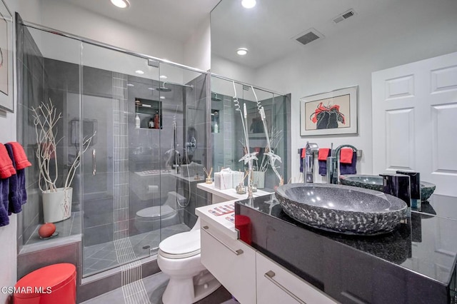 bathroom with vanity, toilet, and walk in shower