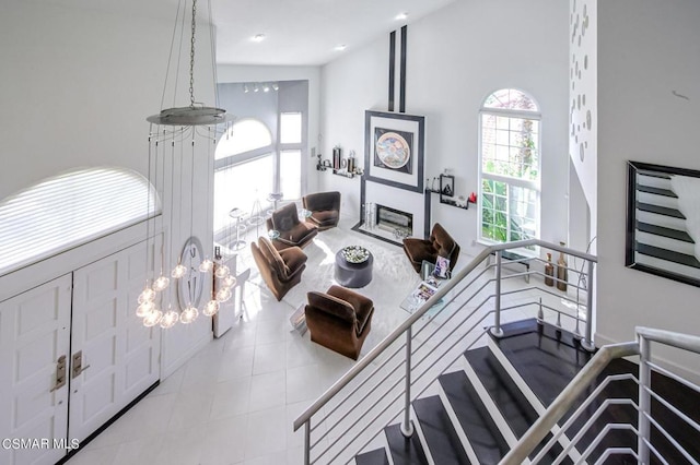 living room featuring a high ceiling and a notable chandelier