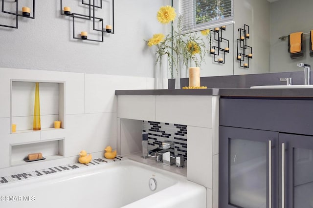 bathroom with vanity and a tub to relax in